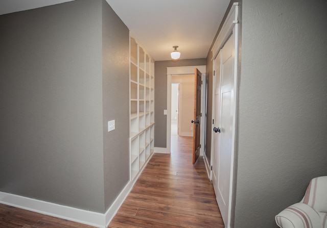 corridor with dark hardwood / wood-style flooring