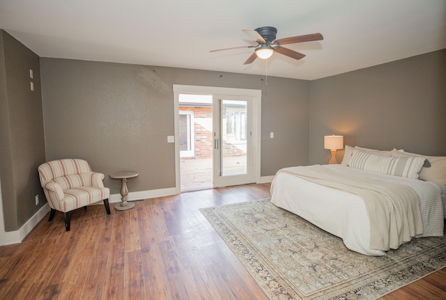 bedroom featuring ceiling fan, wood-type flooring, and access to outside