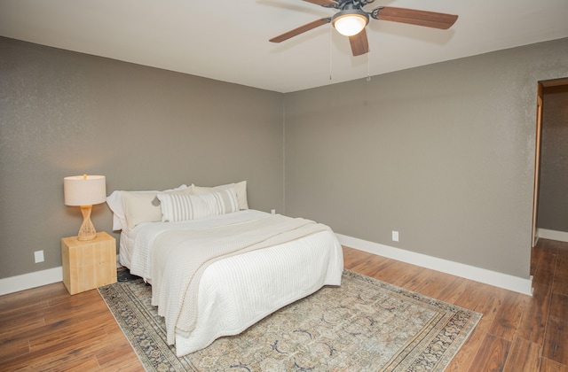 bedroom featuring ceiling fan and dark wood-type flooring