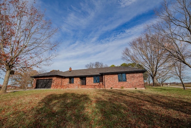 ranch-style home featuring a garage and a front lawn