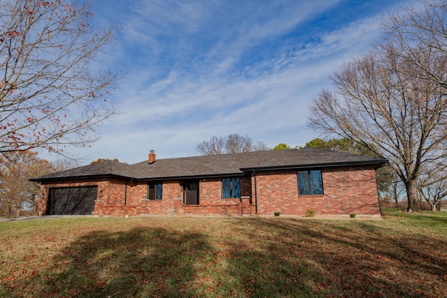 ranch-style house featuring a front lawn and a garage