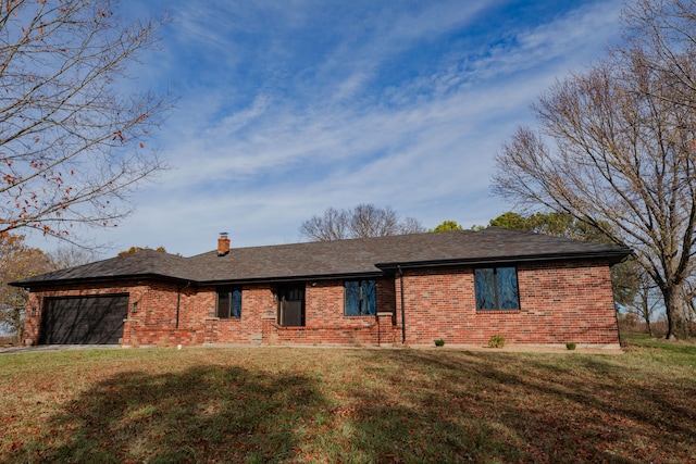 ranch-style home with a front yard and a garage