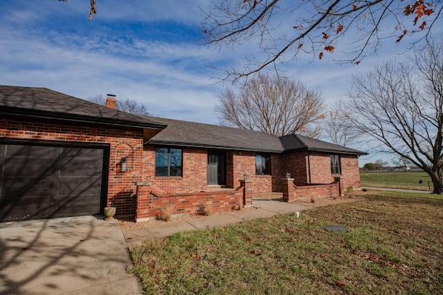 view of front of property with a garage and a front yard