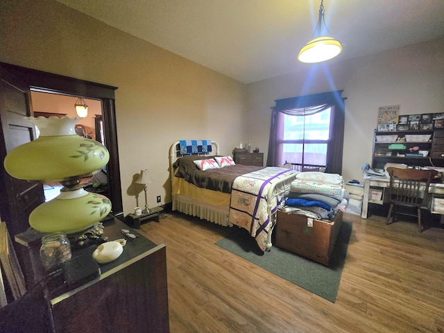 bedroom featuring hardwood / wood-style floors and vaulted ceiling