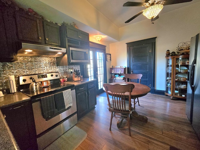 kitchen featuring backsplash, stainless steel appliances, ceiling fan, and dark wood-type flooring