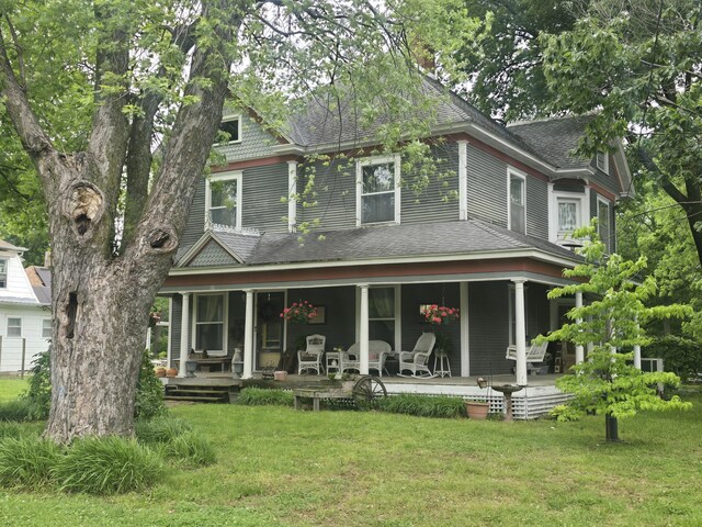 106 N Main St, Greenfield, MO 65661 - back of property with covered porch, a lawn, and roof with shingles