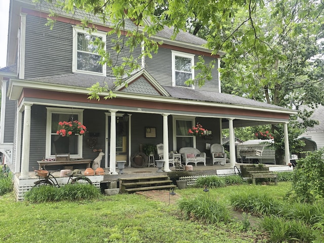 106 N Main St, Greenfield, MO 65661 - rear view of house featuring a porch, a shingled roof, and a lawn