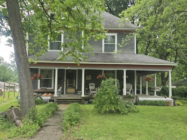 106 N Main St, Greenfield, MO 65661 - view of front of house with roof with shingles, a front lawn, and covered porch