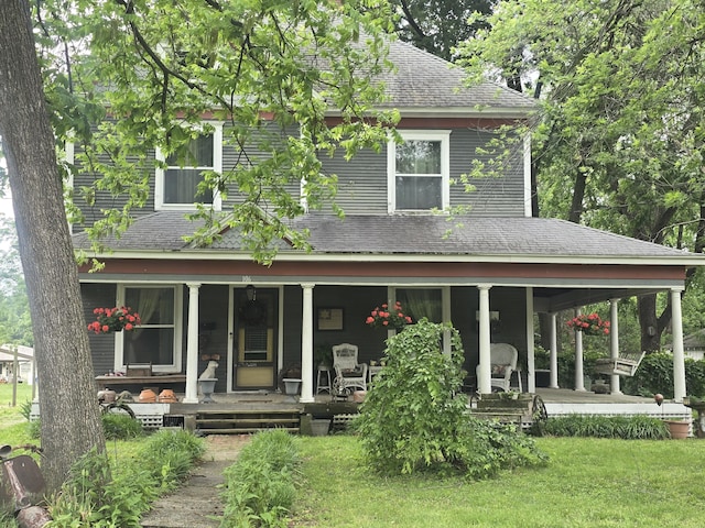 106 N Main St, Greenfield, MO 65661 - rear view of property featuring a shingled roof, a porch, and a yard