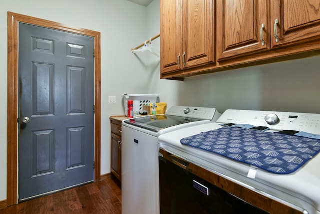 clothes washing area with cabinets, dark hardwood / wood-style flooring, and washer and dryer