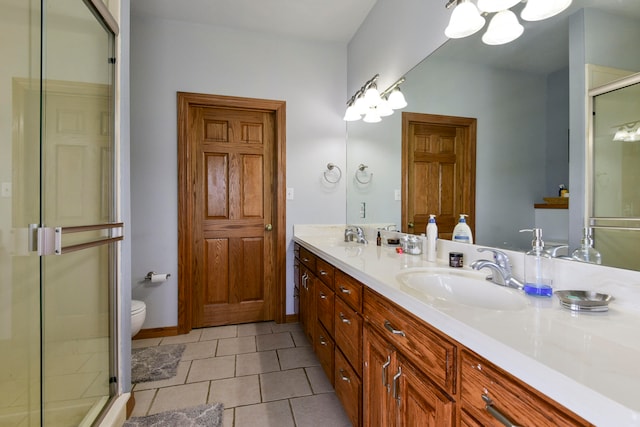 bathroom with toilet, vanity, tile patterned floors, and walk in shower