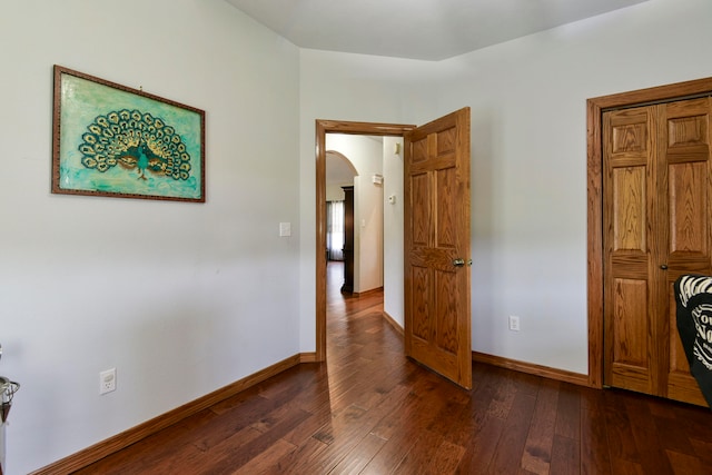 unfurnished bedroom featuring dark wood-type flooring