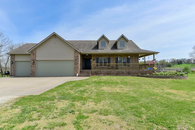 view of front of house featuring a front lawn, covered porch, and a garage