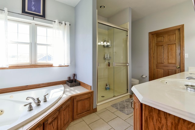 full bathroom featuring toilet, vanity, tile patterned floors, and a wealth of natural light