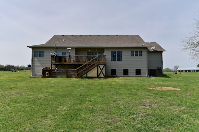 back of house with a lawn and a deck