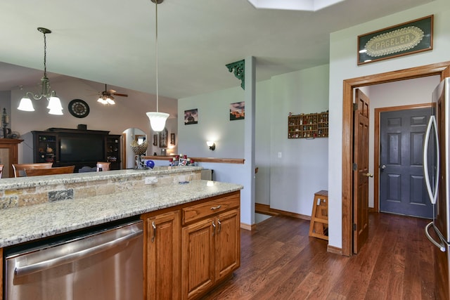 kitchen with dark hardwood / wood-style flooring, pendant lighting, ceiling fan with notable chandelier, and appliances with stainless steel finishes