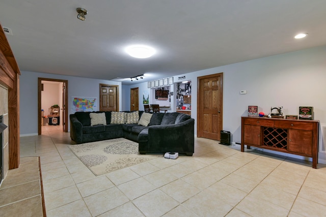 living room with a fireplace and light tile patterned floors