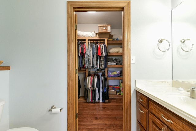 bathroom featuring hardwood / wood-style floors, vanity, and toilet