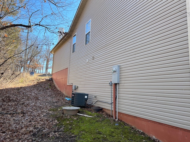 view of side of home with central air condition unit