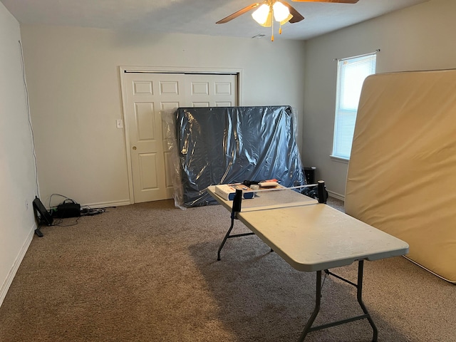 carpeted home office with ceiling fan