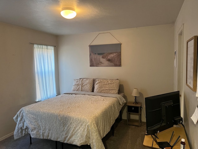 carpeted bedroom with a textured ceiling