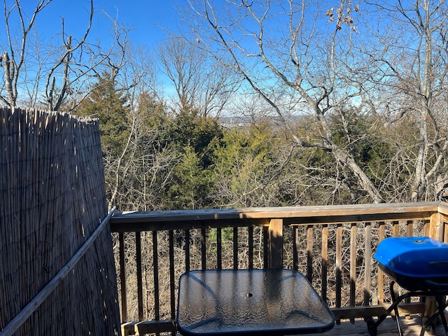 wooden terrace with a grill