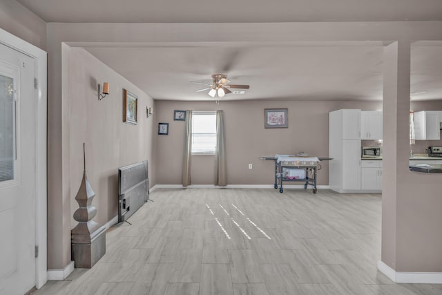 unfurnished living room with ceiling fan