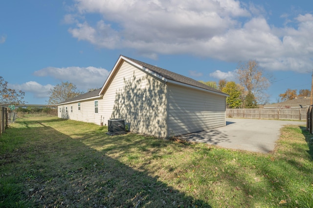 view of property exterior with a lawn, central air condition unit, and a patio