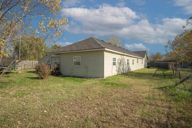 view of side of home with a lawn