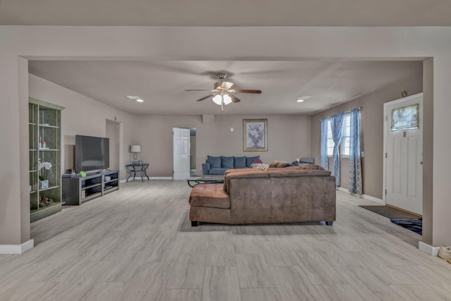 living room featuring ceiling fan and light hardwood / wood-style floors