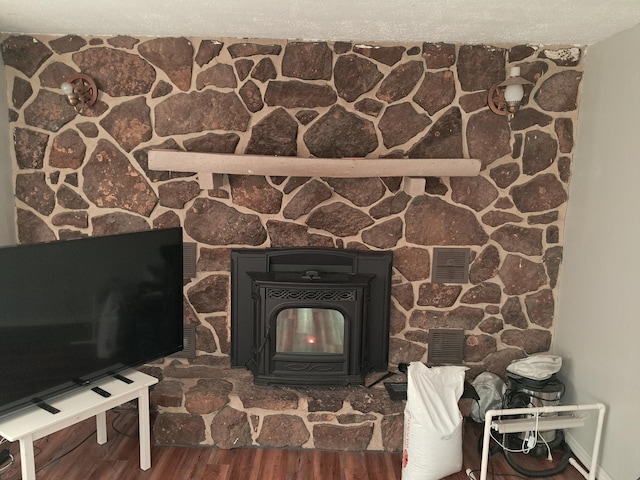 details with a wood stove, hardwood / wood-style floors, and a textured ceiling