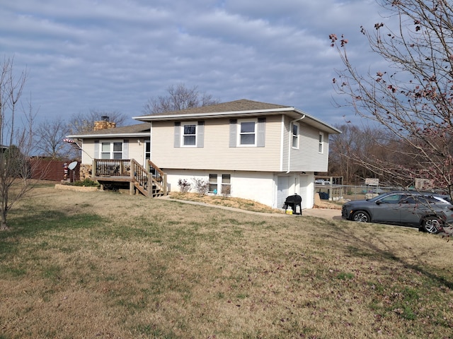 rear view of house featuring a yard and a deck