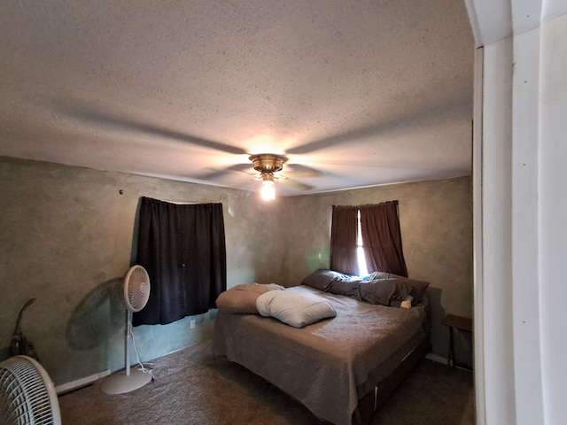 bedroom featuring ceiling fan and a textured ceiling