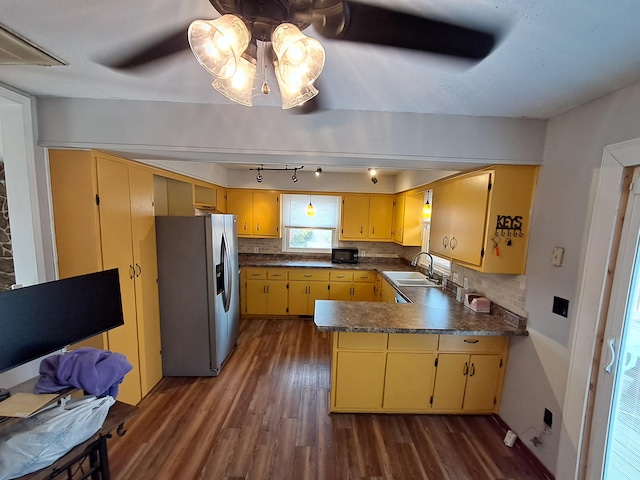 kitchen featuring stainless steel refrigerator with ice dispenser, dark hardwood / wood-style flooring, backsplash, ceiling fan, and sink