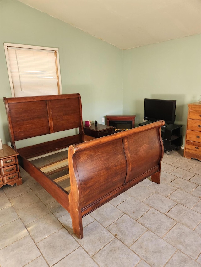 bedroom featuring light tile patterned floors and vaulted ceiling