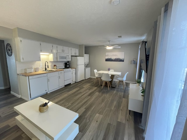 interior space with white cabinetry, white appliances, dark wood-type flooring, and tasteful backsplash