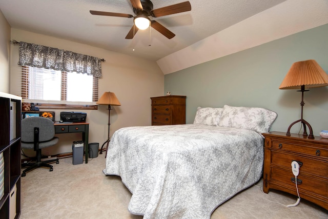 bedroom with a textured ceiling, ceiling fan, light carpet, and vaulted ceiling