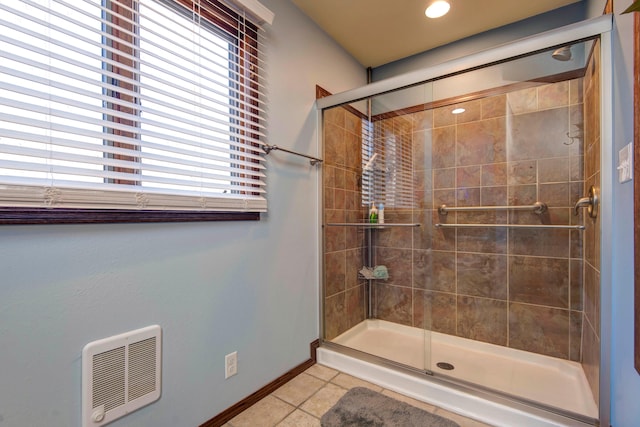 bathroom featuring tile patterned flooring, walk in shower, and heating unit