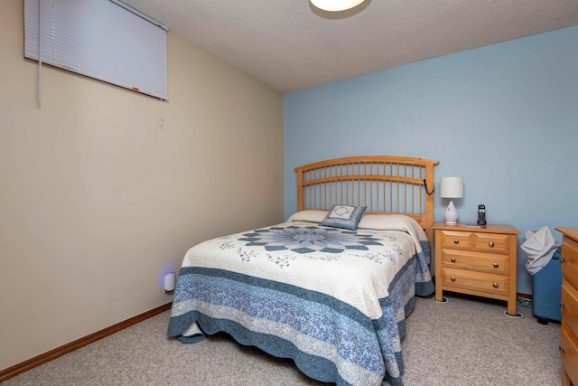 bedroom featuring carpet flooring and a textured ceiling