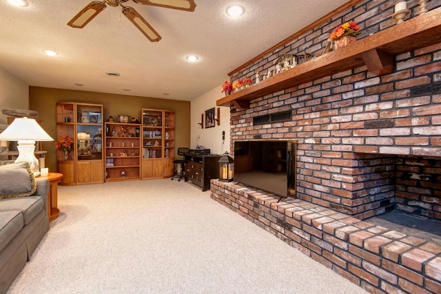 living room featuring ceiling fan, carpet, and a textured ceiling