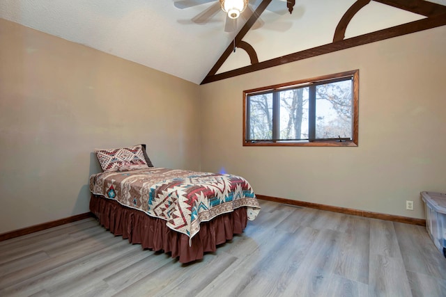 bedroom with ceiling fan, light hardwood / wood-style flooring, and high vaulted ceiling