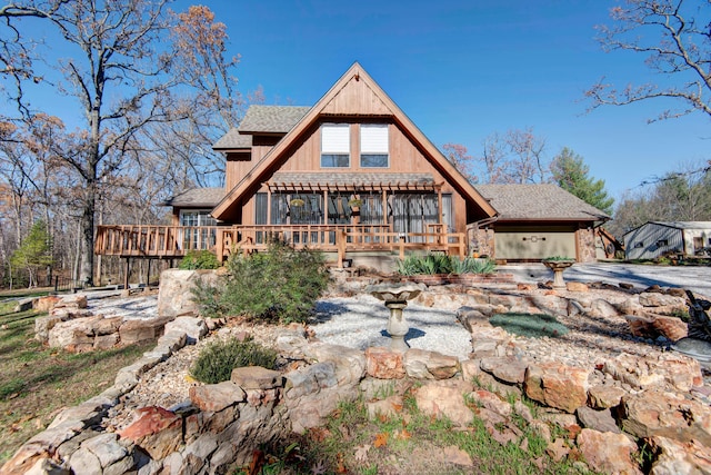 rear view of property featuring a deck