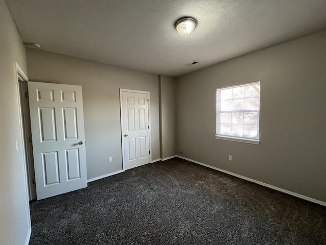 66 Celebration Dr, Reeds Spring, MO 65737 - unfurnished bedroom featuring dark colored carpet and baseboards