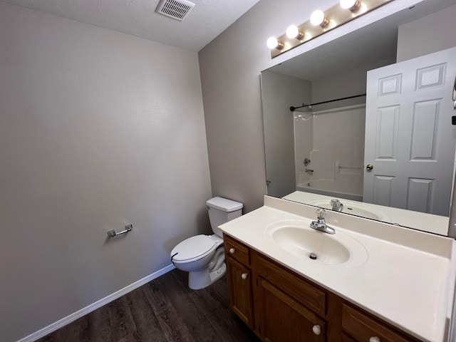 full bathroom with vanity, a textured ceiling, shower / tub combination, hardwood / wood-style floors, and toilet