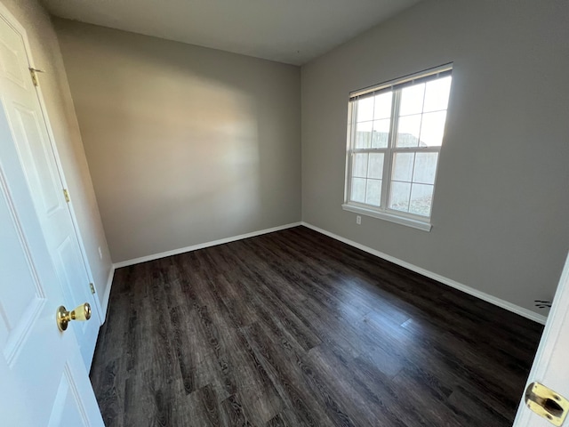 empty room featuring dark wood-type flooring