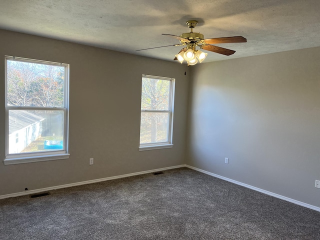 66 Celebration Dr, Reeds Spring, MO 65737 - spare room with a ceiling fan, dark carpet, a textured ceiling, and baseboards