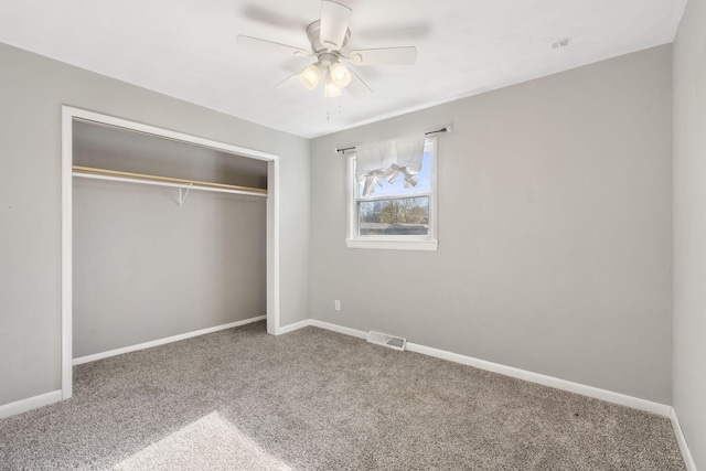 unfurnished bedroom with carpet, a closet, and ceiling fan