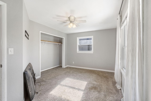 unfurnished bedroom with carpet, ceiling fan, and a closet