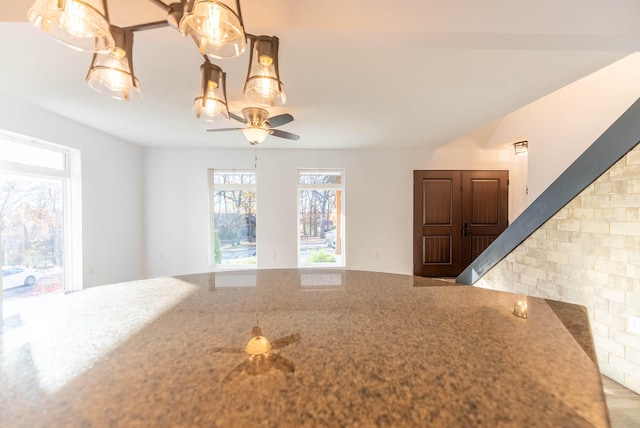 kitchen with ceiling fan, pendant lighting, and hardwood / wood-style flooring