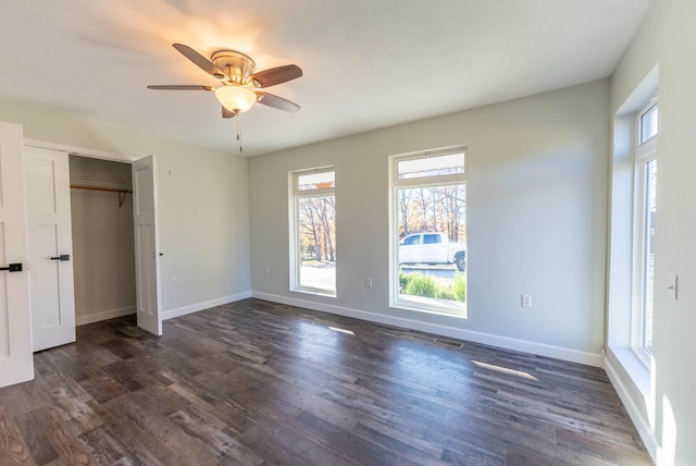 unfurnished bedroom featuring ceiling fan, dark hardwood / wood-style floors, and a closet